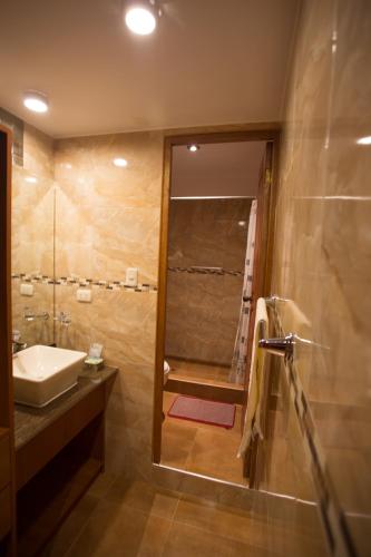 a bathroom with a sink and a shower at El Mariscal Cusco in Cusco