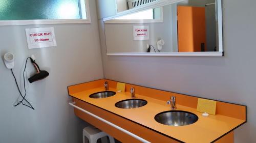 a bathroom with two sinks and a mirror at Fairlie Holiday Park in Fairlie