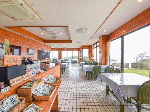 a fast food restaurant with tables and chairs and windows at Pension Hoshinosuna in Iriomote