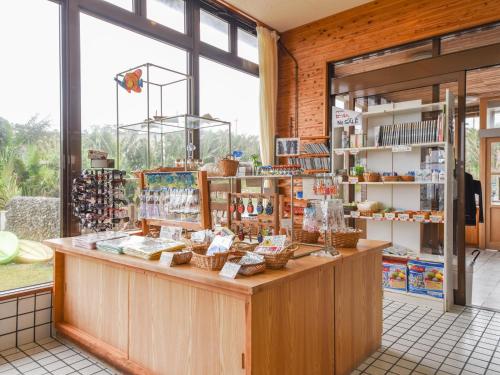 a store with a counter with baskets of food at Pension Hoshinosuna in Iriomote