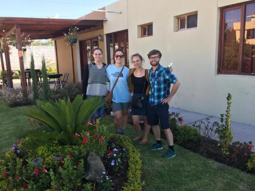 a group of people standing in front of a house at Hotel Las Mercedes Airport-Quito in Tababela