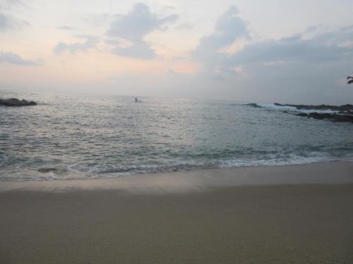 a boat in the ocean on the beach at Sanderling Silent Beach Cabanas in Tangalle