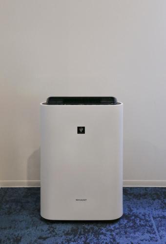 a white refrigerator sitting next to a wall at Hotel Code Shinsaibashi in Osaka