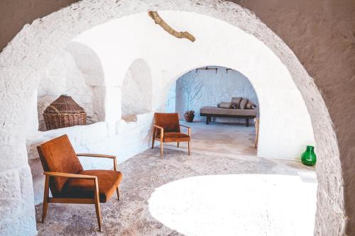a living room with two chairs and a couch at Materiis in Noci