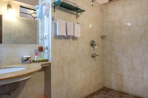 a bathroom with a sink and a shower at Rawla Rawatsar in Jaipur