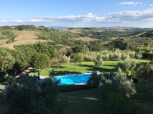 an estate with a swimming pool in a field at Podere Casanova in Montespertoli