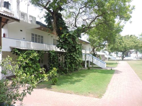 a building with ivy growing on the side of it at Pigeon Island Beach Resort and Spa in Nilaveli