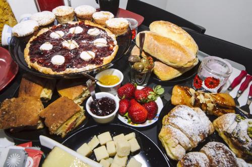 a table topped with lots of different types of bread and pastries at B&B Sbarco dei 1000 in Marsala