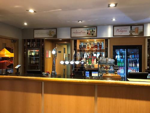 a bar in a pub with a lot of alcohol at Turlin Valley in Poole