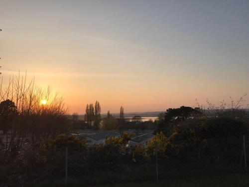 a sunset view from the balcony of a house at Turlin Valley in Poole