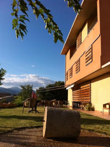 a building with a rock in front of it at Hotel Era Conte in Bierge