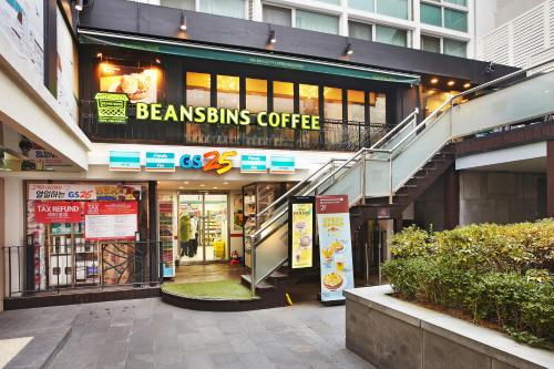 a building with a sign for abucks coffee shop at Savoy Hotel Myeongdong in Seoul