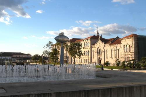 a building with a fountain in front of a building at Hotel do Lago in Braga