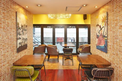 a restaurant with tables and chairs in a room at Savoy Hotel Myeongdong in Seoul