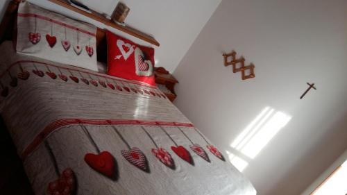 a bedroom with a bed with hearts on it at Casa delle Rose in Teglio