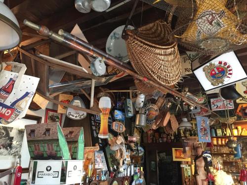 a shop with a bunch of items on the ceiling at La Remise - Les Chambres in Neufchâteau