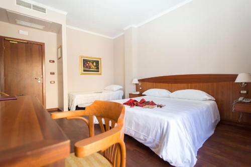 Postel nebo postele na pokoji v ubytování Hotel Cavaliere