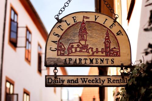 a sign for a dairy and weekly rental on a building at Castle View Apartments in Český Krumlov