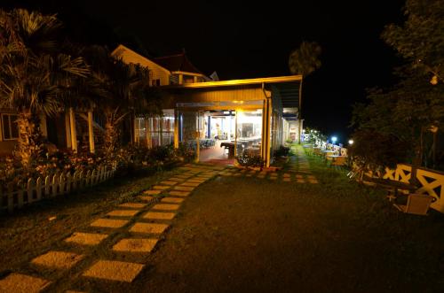 a house lit up at night with a walkway at Cingjing Brilliant Twins of Seattle in Renai