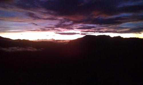 a sunset over a mountain range with the sun setting at Cingjing Brilliant Twins of Seattle in Renai