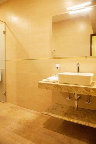 a bathroom with a sink and a mirror at The Ivy House in Kolkata