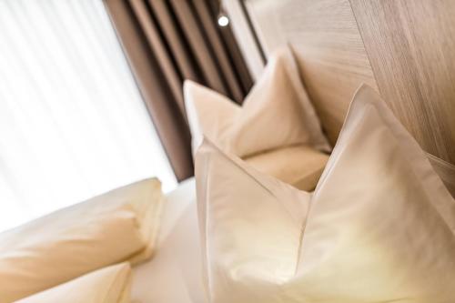 a white chair sitting next to a window at Hotel Miramonti Badia in Badia