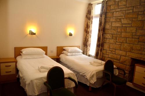 A bed or beds in a room at Spean Bridge Hotel