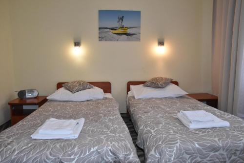 two beds in a hotel room with towels on them at Hotel *** NAT Kołobrzeg in Kołobrzeg