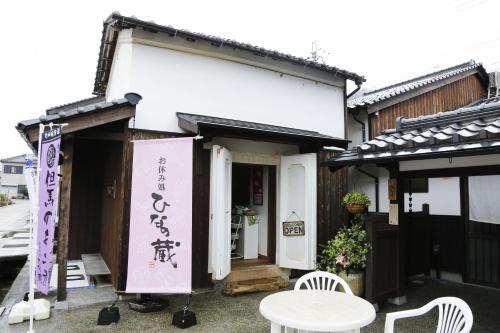 a person standing outside of a building with a sign at Terakoya Hanatei in Asago