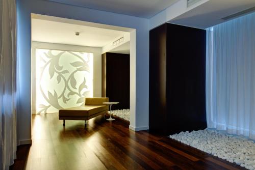 a living room with a chair and a table at VIP Grand Lisboa Hotel & Spa in Lisbon