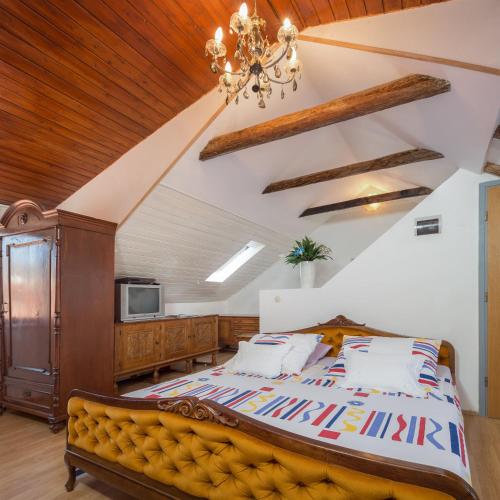 a bedroom with a large bed and a chandelier at Apartment Patricia in Trogir