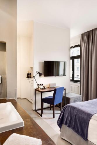 a hotel room with a bed and a desk with a computer at Lux 11 Berlin-Mitte in Berlin