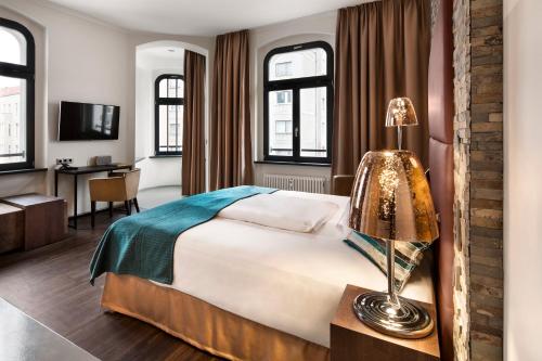a bedroom with a large bed and a large window at Lux 11 Berlin-Mitte in Berlin