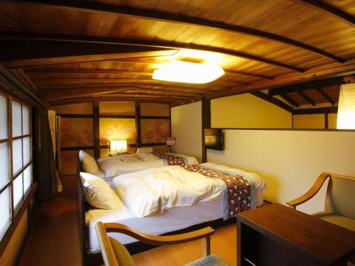 a bedroom with a large bed in a room at Terakoya Hanatei in Asago