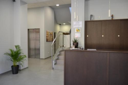 a lobby with a staircase and a reception desk at Pensión Lemos in Tríacastela
