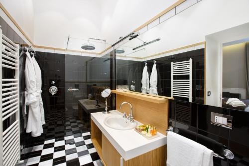 La salle de bains est pourvue d'un lavabo et d'un sol en damier noir et blanc. dans l'établissement Nap Luxury Guest House, à Naples