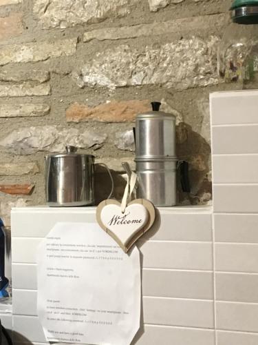 a heart shaped sign on a table with pots and pans at Apartments Aurora Delle Rose in Assisi