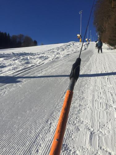 an orange pole in the snow on a ski slope at Penzion Farma Žleby in České Žleby