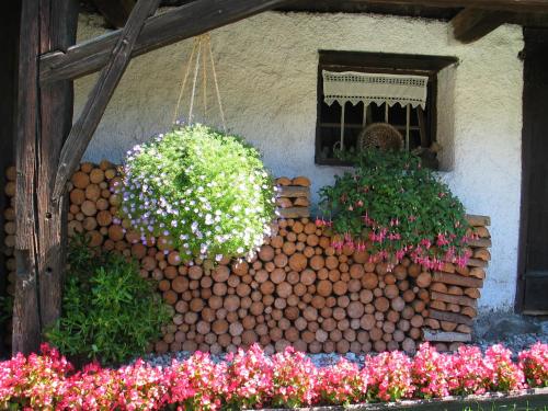 a bunch of flowers in front of a window at Ferienhaus Sternhof in Mieders