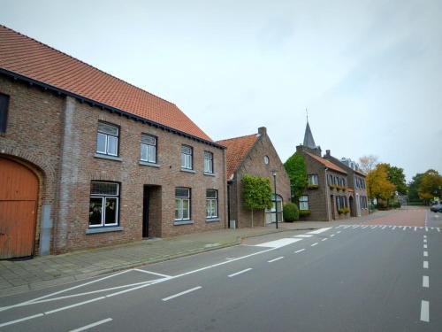an empty street in a town with brick buildings at Cozy apartment in Roasting near the Belgian border in Roosteren