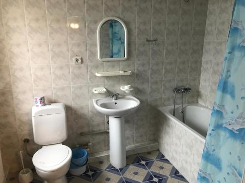 a bathroom with a toilet and a sink and a tub at Zhovtnevyi in Vinnytsya