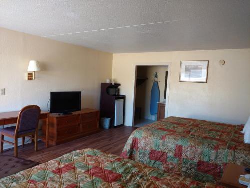 a hotel room with two beds and a flat screen tv at Mount Vernon Inn in Sumter