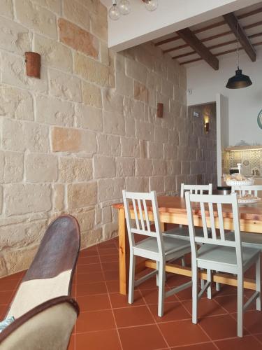 uma sala de jantar com mesa e cadeiras e uma parede de tijolos em My Rooms Ciutadella Adults Only by My Rooms Hotels em Ciutadella