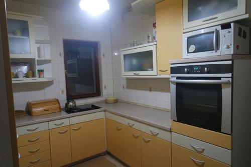 a kitchen with a microwave and a stove at Luxury house in heart of Old town Bascarsija in Sarajevo