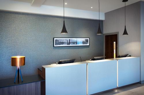an office with a reception desk with two desks at Leonardo Hotel East Midlands Airport in Castle Donington