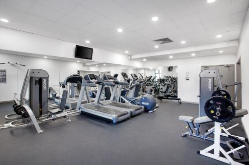 a gym with several treadmills and machines at Leonardo Hotel East Midlands Airport in Castle Donington