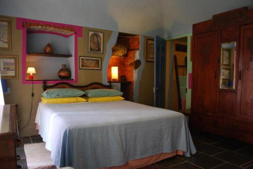 a bedroom with a bed with a white bedspread at Villa Emilia in Roppolo