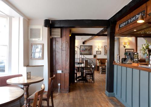 a restaurant with a table and chairs and a bar at The Green Dragon in Marlborough
