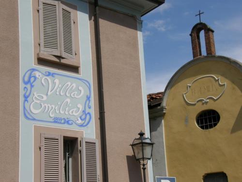 a church with a sign on the side of a building at Villa Emilia in Roppolo