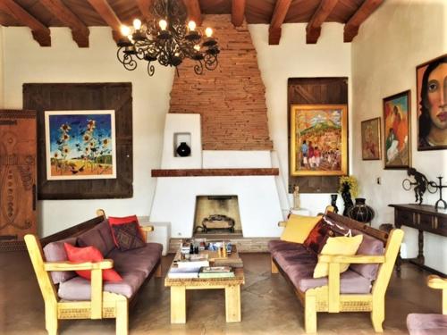 a living room with a couch and a fireplace at Casa Benavides Inn in Taos